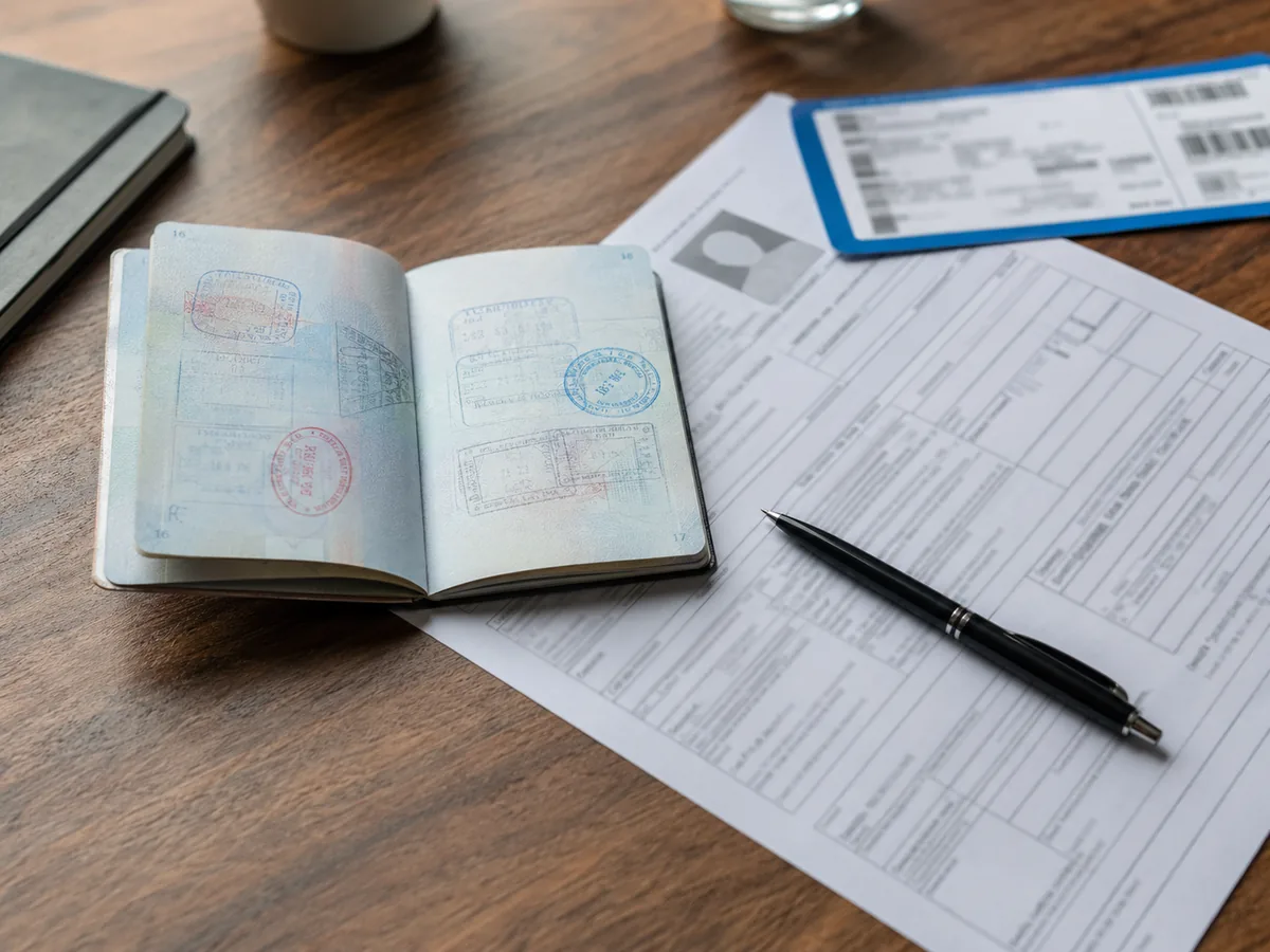 Colombian passport stamps and visa paperwork laid out on a desk