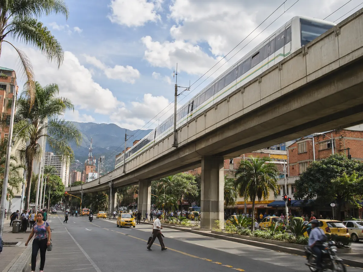 Street-level view of Medellín with the Metro line crossing the city